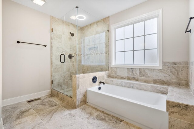 2240 Killington Dr, Clarksville, TN 37040 - bathroom with a garden tub, a stall shower, and baseboards