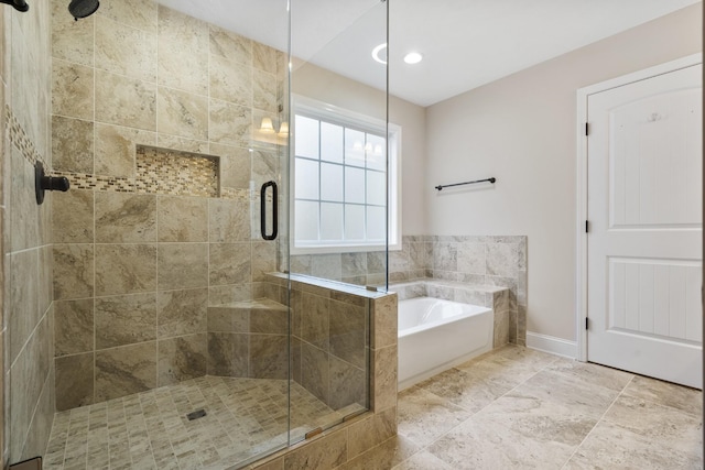 2240 Killington Dr, Clarksville, TN 37040 - bathroom featuring a shower stall, a garden tub, and baseboards