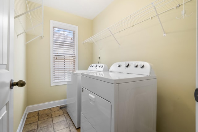 2240 Killington Dr, Clarksville, TN 37040 - washroom featuring separate washer and dryer, baseboards, and light stone finish floors