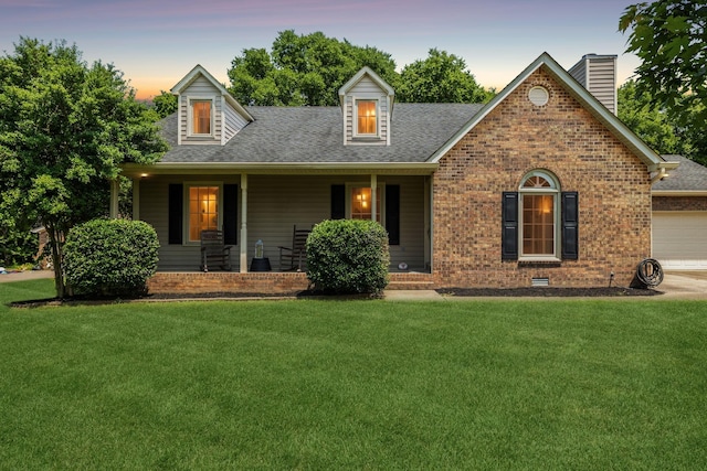 2118 Winthorne Ln, Murfreesboro, TN 37129 - cape cod-style house with a front lawn, covered porch, brick siding, and a garage
