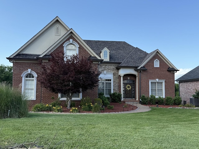 140 W Twelve Stones Xing, Goodlettsville, TN 37072 - view of front of property featuring a front lawn, brick siding, and roof with shingles
