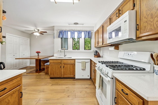2416 Ravine Dr, Nashville, TN 37217 - kitchen with white appliances, a sink, brown cabinetry, and a ceiling fan