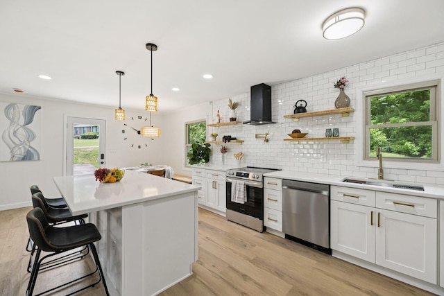170 Old Carters Creek Pike, Franklin, TN 37064 - kitchen with stainless steel appliances, wall chimney range hood, a sink, backsplash, and light countertops