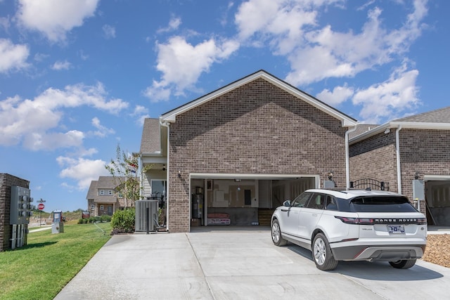 1079 Wrights Mill Rd Unit H8, Spring Hill, TN 37174 - view of side of property with concrete driveway, brick siding, an attached garage, a yard, and cooling unit