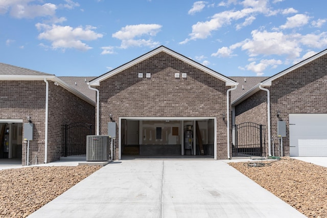 1079 Wrights Mill Rd Unit H8, Spring Hill, TN 37174 - view of front of home featuring driveway, brick siding, a garage, and cooling unit