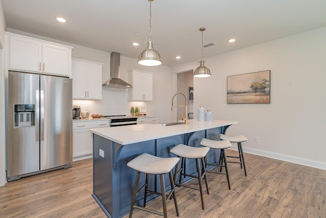 1079 Wrights Mill Rd Unit H8, Spring Hill, TN 37174 - kitchen with stainless steel appliances, wall chimney range hood, a sink, an island with sink, and a breakfast bar