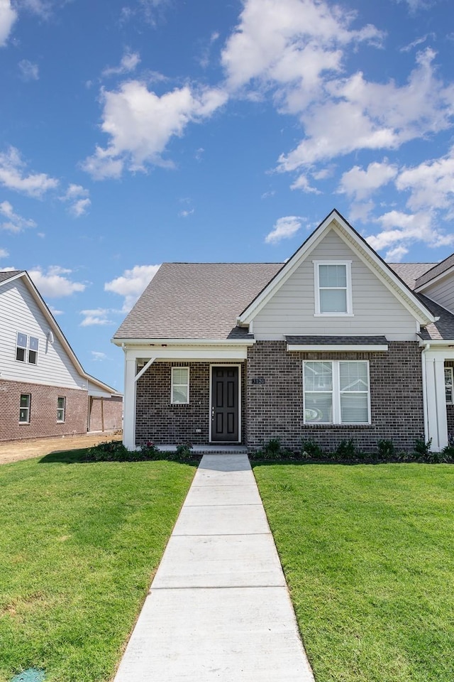 1079 Wrights Mill Rd Unit H8, Spring Hill, TN 37174 - traditional-style house with brick siding, a front yard, and a shingled roof