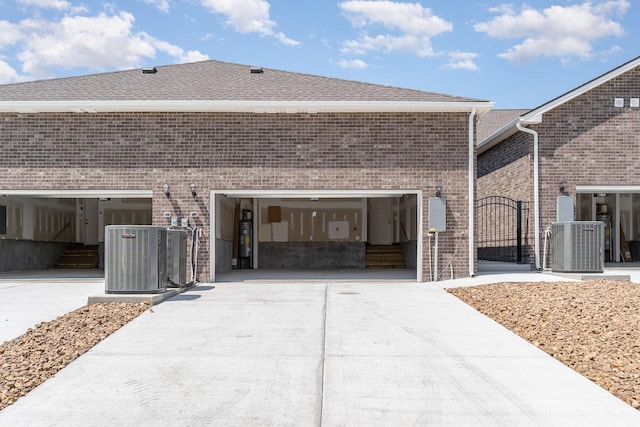 1079 Wrights Mill Rd Unit H8, Spring Hill, TN 37174 - view of side of home with concrete driveway, brick siding, central AC unit, and roof with shingles