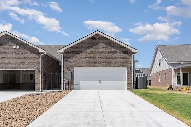 1079 Wrights Mill Rd Unit H8, Spring Hill, TN 37174 - view of front facade with brick siding, driveway, a front yard, a garage, and cooling unit