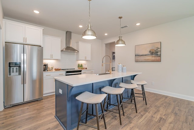 1073 Wrights Mill Rd Unit H-7, Spring Hill, TN 37174 - kitchen with stainless steel appliances, wall chimney range hood, a sink, a center island with sink, and a kitchen bar