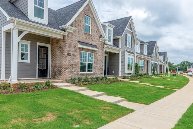 1075 Wrights Mill Rd Unit H-6, Spring Hill, TN 37174 - view of front facade with brick siding, a front yard, a residential view, and roof with shingles