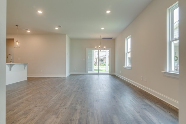 1075 Wrights Mill Rd Unit H-6, Spring Hill, TN 37174 - unfurnished living room featuring a chandelier, wood finished floors, baseboards, and recessed lighting