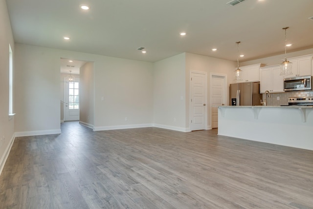 1075 Wrights Mill Rd Unit H-6, Spring Hill, TN 37174 - unfurnished living room featuring light wood-style floors, baseboards, recessed lighting, and a sink