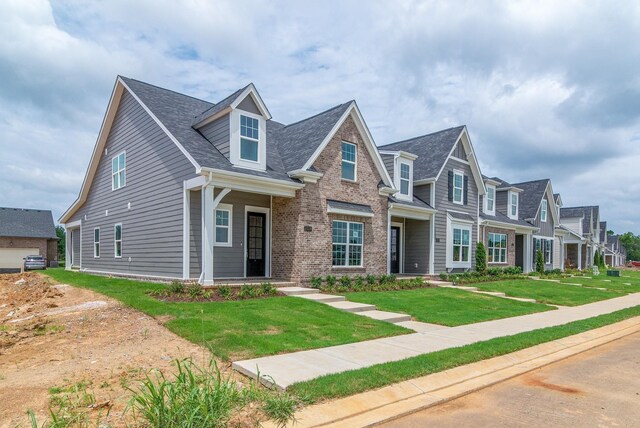 1075 Wrights Mill Rd Unit H-6, Spring Hill, TN 37174 - view of front of property featuring a front yard, brick siding, roof with shingles, and a residential view