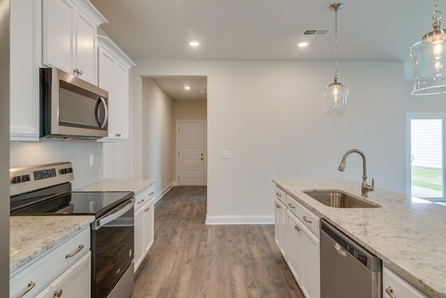 1075 Wrights Mill Rd Unit H-6, Spring Hill, TN 37174 - kitchen with appliances with stainless steel finishes, a sink, dark wood-type flooring, tasteful backsplash, and white cabinets
