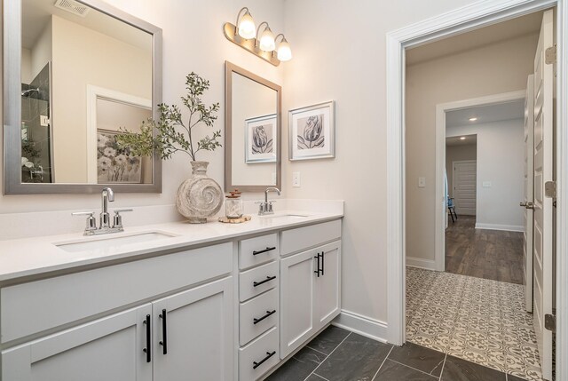 1077 Wrights Mill Rd Unit H-7, Spring Hill, TN 37174 - bathroom featuring double vanity, baseboards, and tiled shower