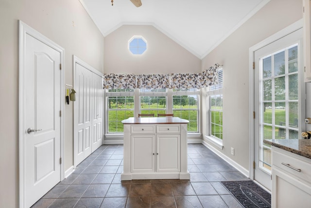 306 S Cameron Ct, Hermitage, TN 37076 - kitchen with lofted ceiling, white cabinetry, a ceiling fan, baseboards, and a kitchen island