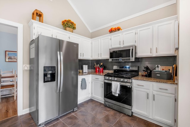 306 S Cameron Ct, Hermitage, TN 37076 - kitchen featuring appliances with stainless steel finishes, lofted ceiling, white cabinets, decorative backsplash, and crown molding