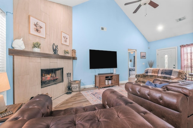 306 S Cameron Ct, Hermitage, TN 37076 - living room featuring high vaulted ceiling, a tiled fireplace, ceiling fan, baseboards, and wood finished floors
