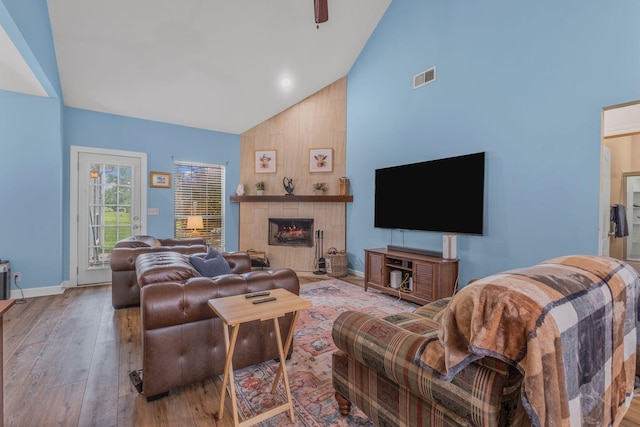 306 S Cameron Ct, Hermitage, TN 37076 - living room featuring high vaulted ceiling, a tile fireplace, wood finished floors, and baseboards