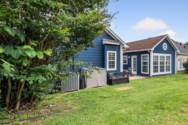 306 S Cameron Ct, Hermitage, TN 37076 - rear view of property featuring a lawn, a patio, and roof with shingles
