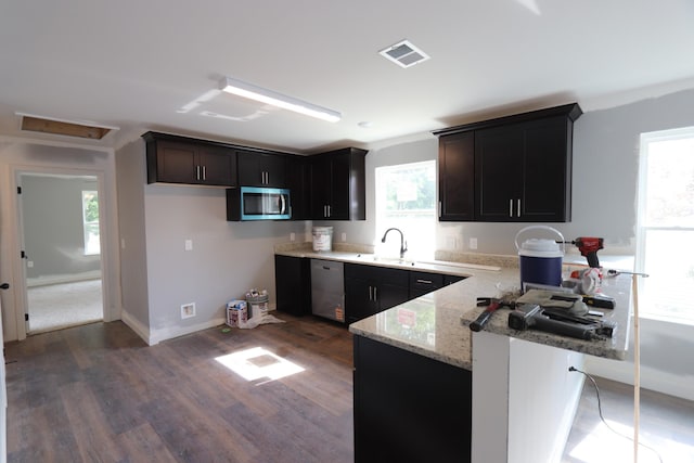 174 Dale St, Red Boiling Springs, TN 37150 - kitchen with stainless steel appliances, a peninsula, light stone countertops, and dark wood-style floors