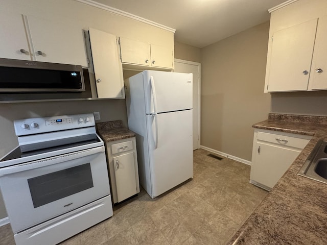 513 Adams Ct, Clarksville, TN 37040 - kitchen featuring white appliances, baseboards, dark countertops, and white cabinetry