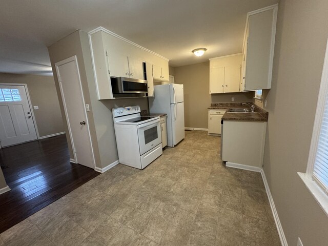 513 Adams Ct, Clarksville, TN 37040 - kitchen with white appliances, a sink, white cabinetry, and baseboards