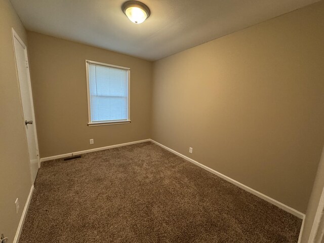 513 Adams Ct, Clarksville, TN 37040 - unfurnished room featuring baseboards and dark carpet