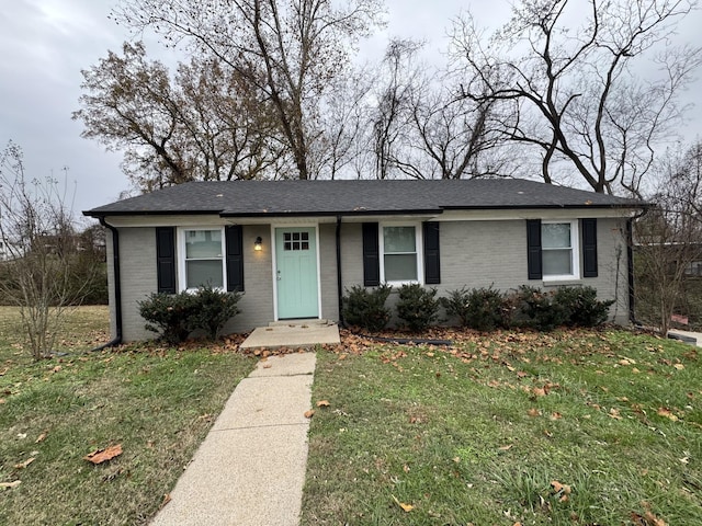 513 Adams Ct, Clarksville, TN 37040 - view of front of house with a front lawn, brick siding, and a shingled roof