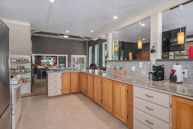 1791 Deer Creek Rd, Linden, TN 37096 - kitchen with white range, light stone countertops, light tile patterned flooring, open floor plan, and freestanding refrigerator