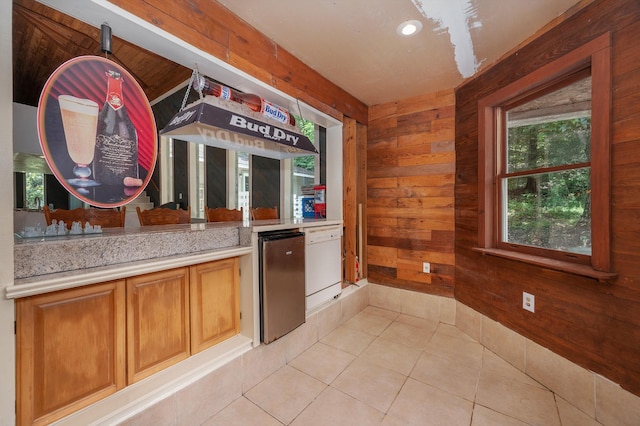 1791 Deer Creek Rd, Linden, TN 37096 - kitchen with wooden walls, light countertops, light tile patterned flooring, fridge, and recessed lighting