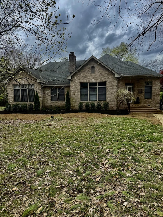 5544 S New Hope Rd, Hermitage, TN 37076 - ranch-style house with a chimney, a front yard, and a shingled roof