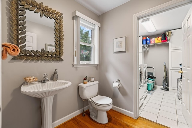 5544 S New Hope Rd, Hermitage, TN 37076 - bathroom featuring separate washer and dryer, baseboards, toilet, and wood finished floors