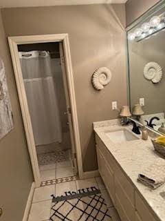 5544 S New Hope Rd, Hermitage, TN 37076 - full bathroom featuring double vanity, curtained shower, tile patterned flooring, and baseboards