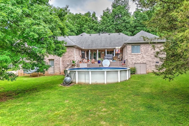 5544 S New Hope Rd, Hermitage, TN 37076 - back of house with brick siding, a yard, and a shingled roof