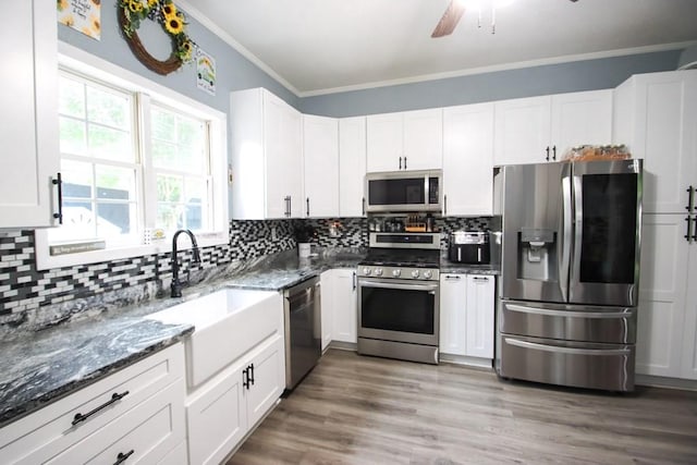 1375 Roberts Matthews Hwy, Sparta, TN 38583 - kitchen featuring stainless steel appliances, a sink, dark stone counters, ornamental molding, and tasteful backsplash