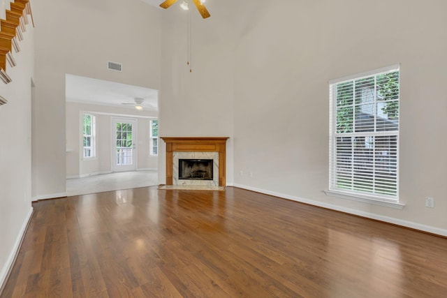 4008 Amber Way, Spring Hill, TN 37174 - unfurnished living room featuring a ceiling fan, wood finished floors, baseboards, a fireplace, and a towering ceiling