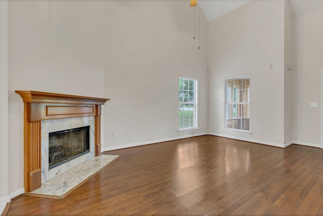 4008 Amber Way, Spring Hill, TN 37174 - unfurnished living room featuring wood finished floors, a fireplace, baseboards, and lofted ceiling