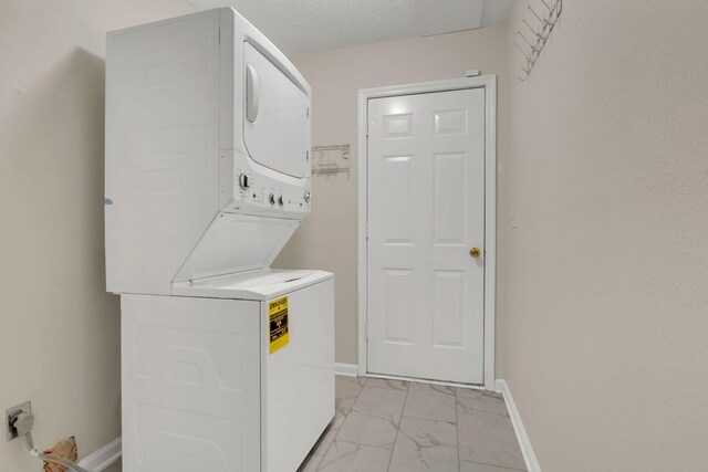 4008 Amber Way, Spring Hill, TN 37174 - washroom with stacked washer / drying machine, light marble finish flooring, and baseboards