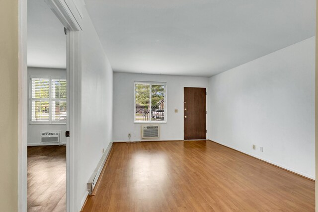 2601 Hillsboro Pike Unit E6, Nashville, TN 37212 - spare room with healthy amount of natural light, wood finished floors, a wall mounted AC, and baseboards
