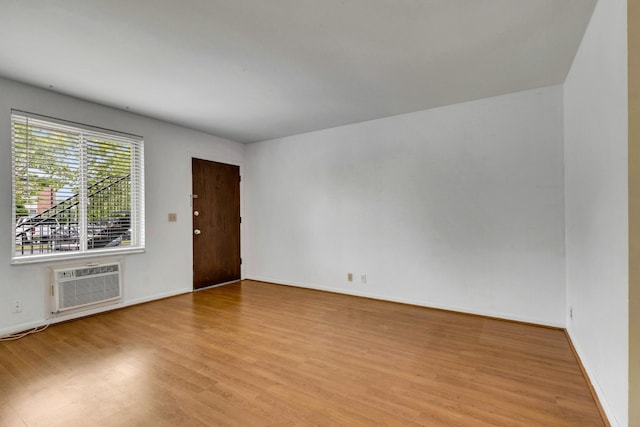 2601 Hillsboro Pike Unit E6, Nashville, TN 37212 - empty room with a wall mounted air conditioner, wood finished floors, and baseboards