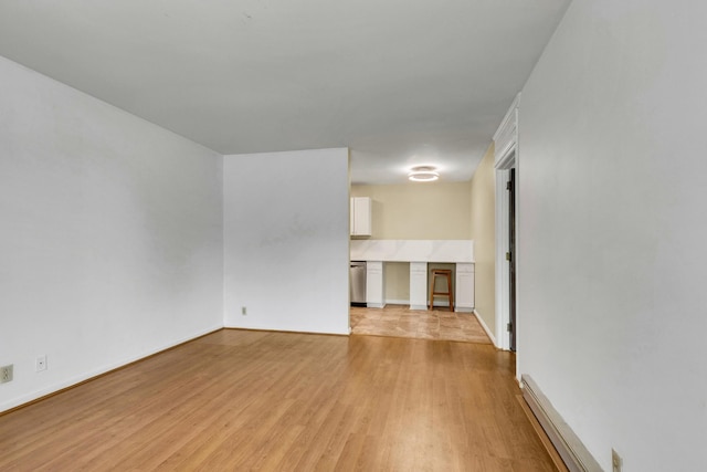 2601 Hillsboro Pike Unit E6, Nashville, TN 37212 - unfurnished living room with light wood-style floors, baseboard heating, and baseboards