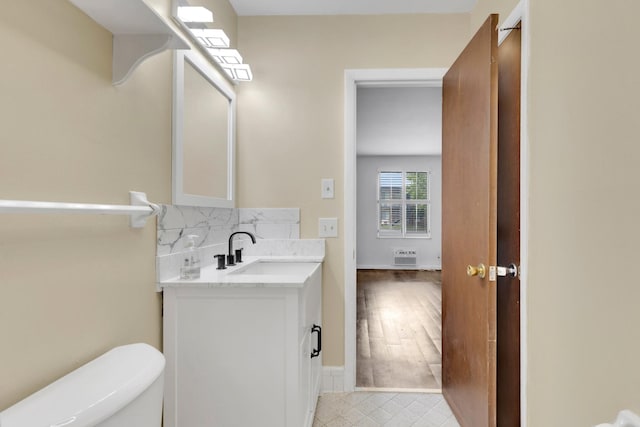 2601 Hillsboro Pike Unit E6, Nashville, TN 37212 - bathroom featuring vanity, toilet, decorative backsplash, baseboards, and tile patterned floors