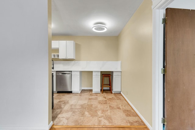 2601 Hillsboro Pike Unit E6, Nashville, TN 37212 - kitchen with dishwasher, white cabinets, baseboards, light countertops, and light stone finish floors