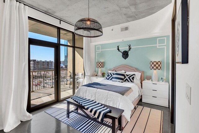 1510 Demonbreun St Unit 810, Nashville, TN 37203 - bedroom with access to exterior, a wall of windows, and finished concrete flooring