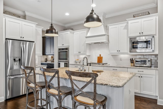 807 Caledonian Ct, Franklin, TN 37064 - kitchen featuring stainless steel appliances, premium range hood, a sink, dark wood finished floors, and a center island with sink