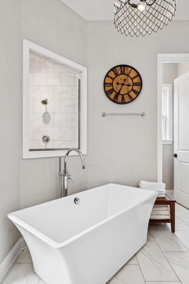 807 Caledonian Ct, Franklin, TN 37064 - bathroom with a soaking tub, marble look tiles, and baseboards