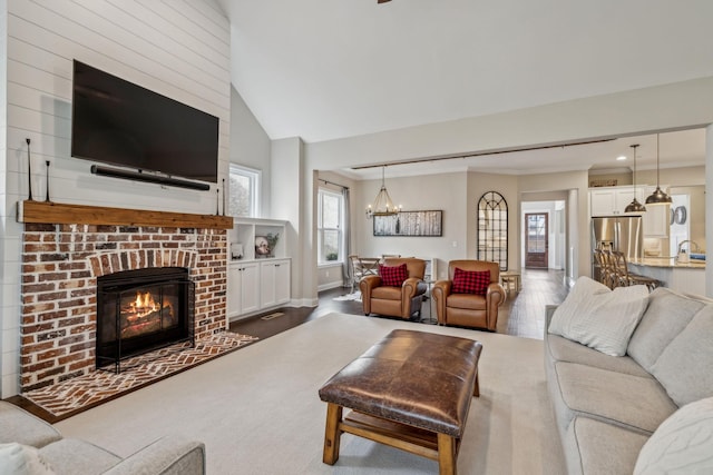 807 Caledonian Ct, Franklin, TN 37064 - living room with a chandelier, a fireplace, and vaulted ceiling