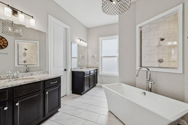 807 Caledonian Ct, Franklin, TN 37064 - full bath featuring marble look tiles, a soaking tub, two vanities, and tiled shower